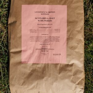 A brown paper bag with pink writing on it.